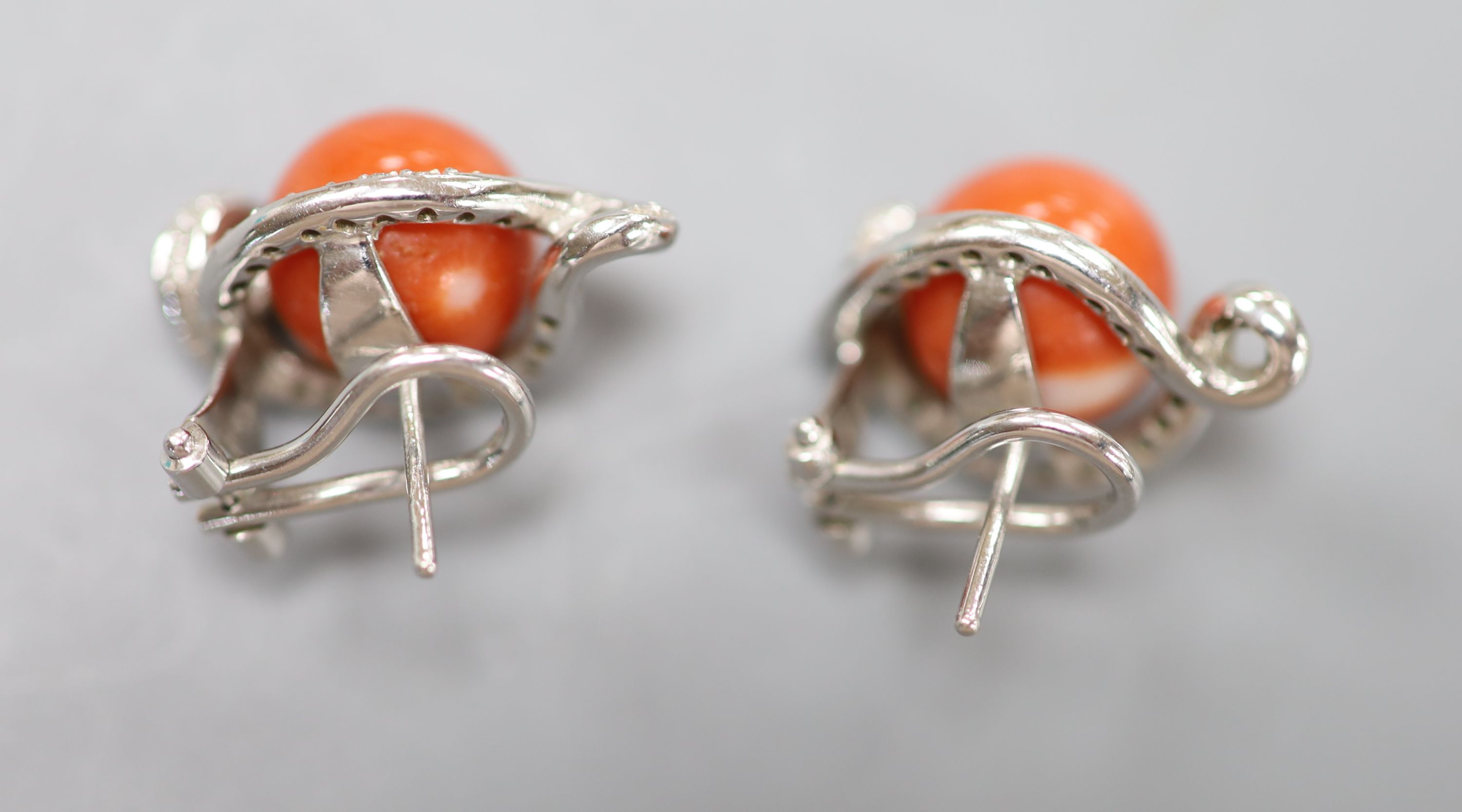 A modern pair of Italian 750 white metal, coral and diamond set earrings, 22mm, gross weight 13.2 grams.